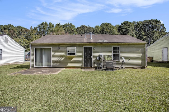 rear view of property featuring a patio area and a yard