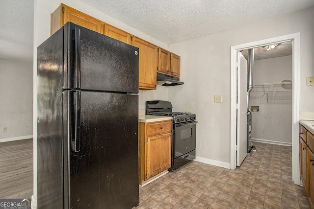 kitchen featuring black appliances and a textured ceiling