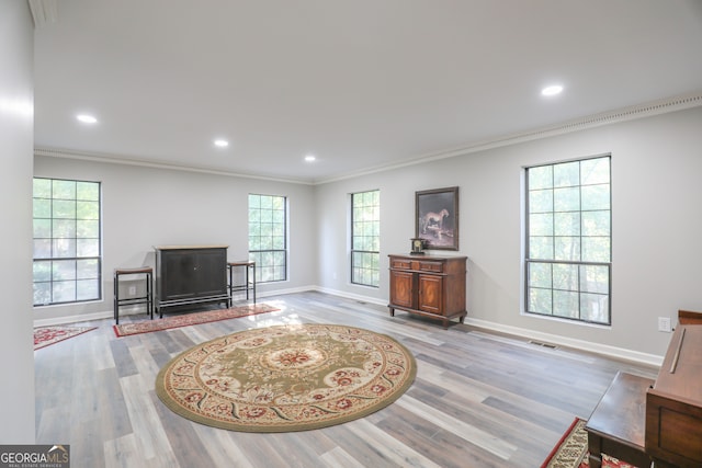 interior space with ornamental molding and light hardwood / wood-style floors