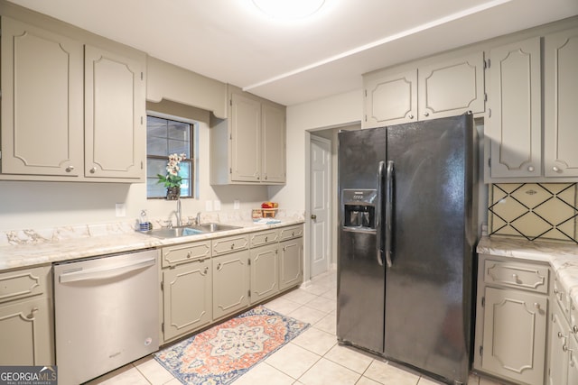 kitchen with black refrigerator with ice dispenser, decorative backsplash, stainless steel dishwasher, and light tile patterned floors