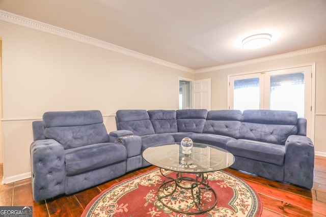 living room featuring dark wood-type flooring and crown molding