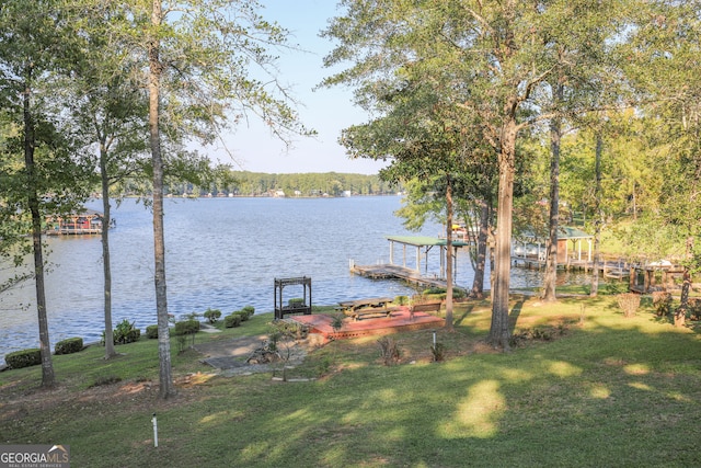 view of dock with a water view and a yard