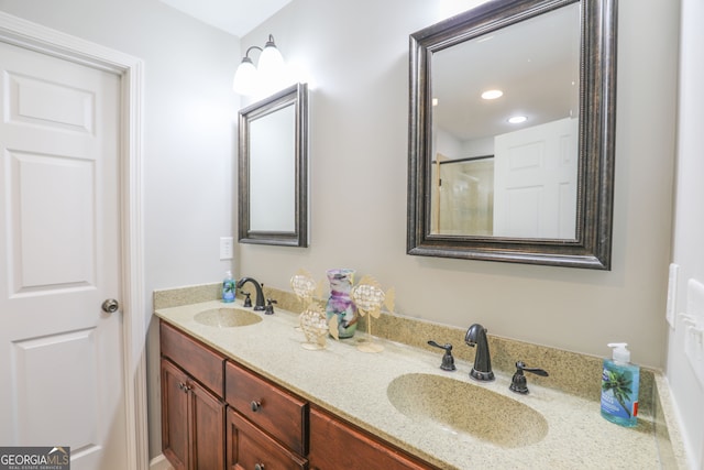 bathroom featuring walk in shower and vanity