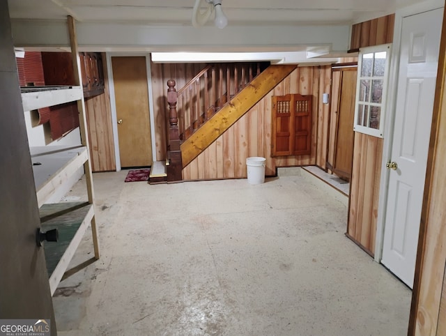 basement featuring wood walls