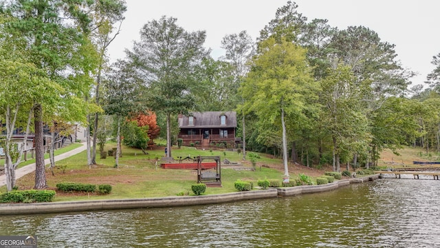 dock area with a water view and a lawn