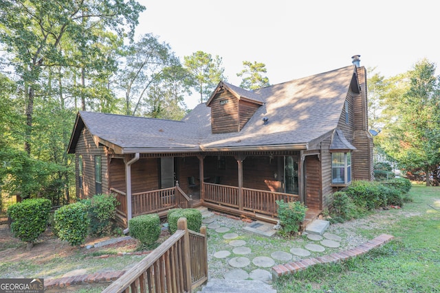 view of front of house with a front lawn and a porch