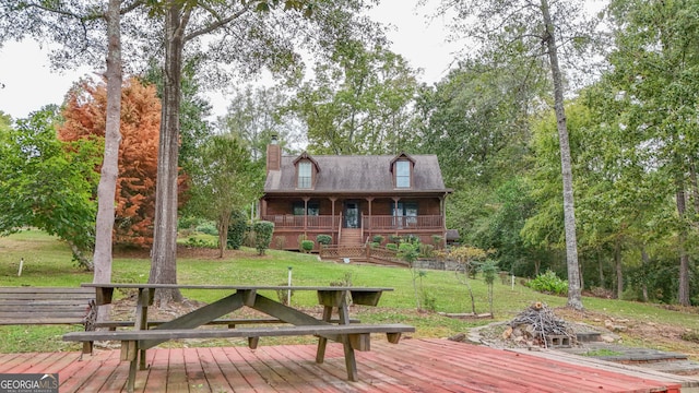 exterior space featuring a front lawn and a deck