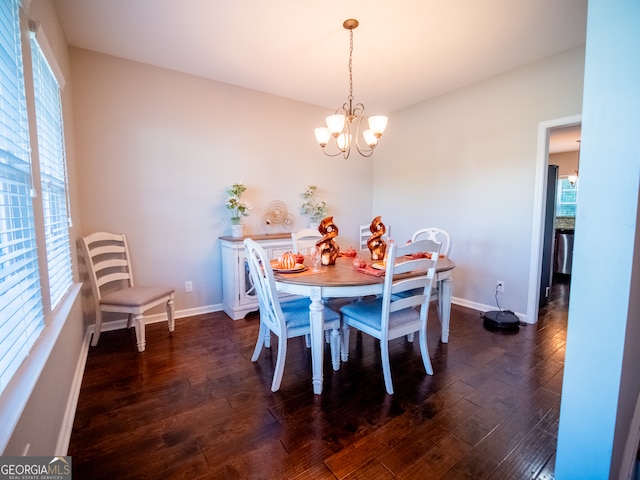 dining room with dark hardwood / wood-style floors and a notable chandelier