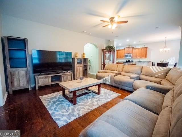 living room featuring dark hardwood / wood-style flooring and ceiling fan with notable chandelier