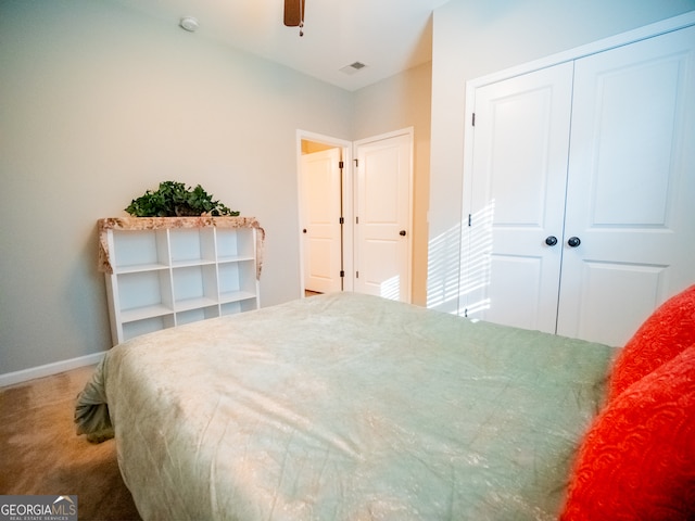 carpeted bedroom featuring a closet and ceiling fan