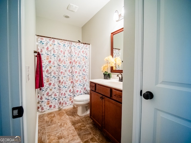 bathroom featuring vanity and toilet