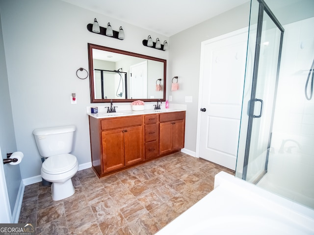 bathroom featuring vanity, toilet, and walk in shower