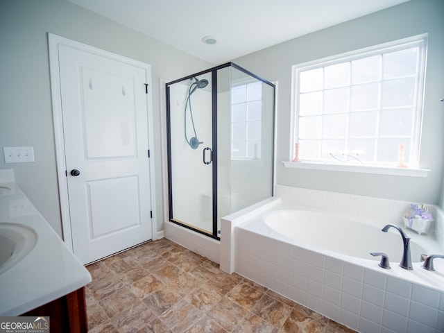 bathroom with vanity and separate shower and tub