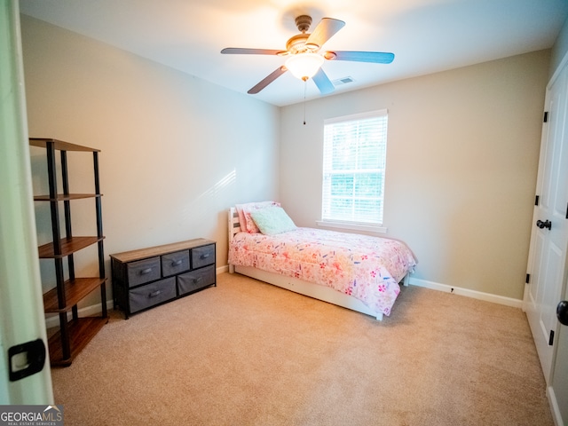 bedroom featuring light colored carpet and ceiling fan