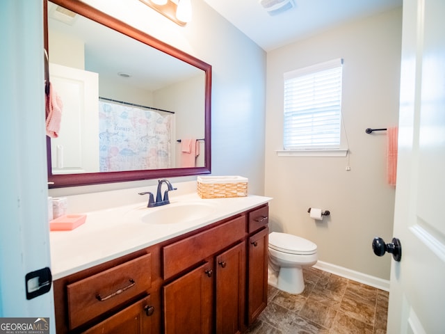 bathroom with vanity and toilet