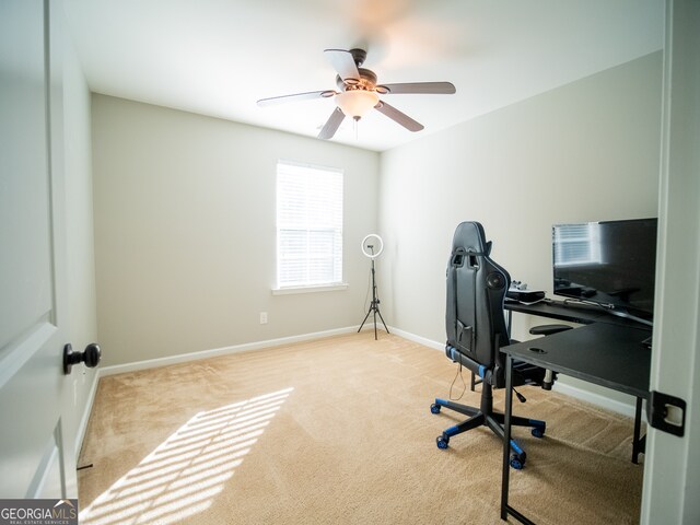 office with light carpet and ceiling fan