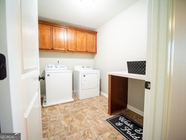 washroom featuring cabinets and washer and dryer