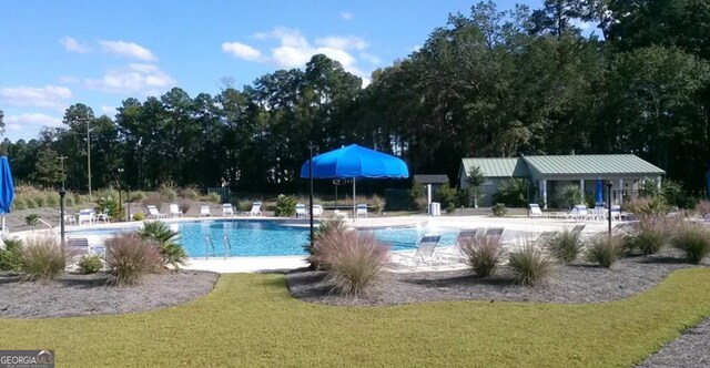 view of swimming pool with a patio area