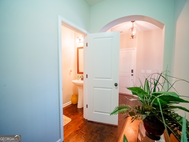 corridor with sink and dark hardwood / wood-style floors