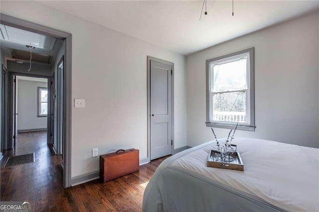 bedroom with dark hardwood / wood-style flooring