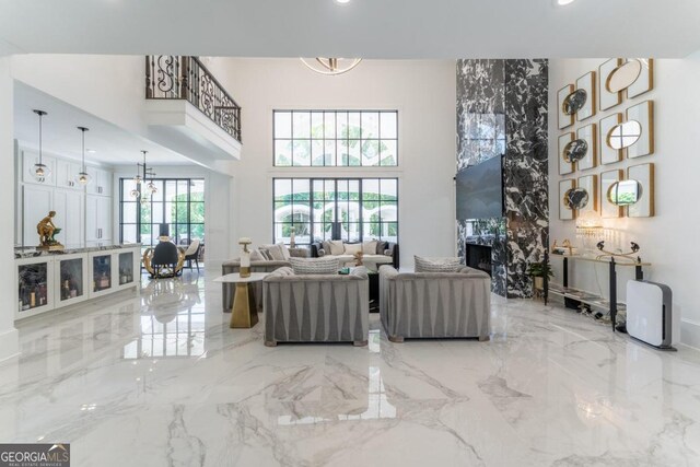 living room featuring a high ceiling and a chandelier