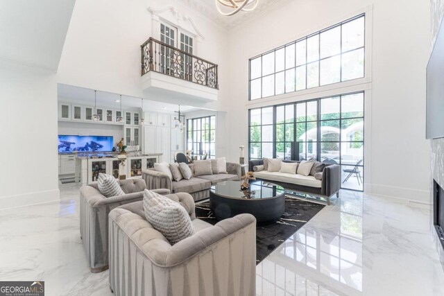 living room featuring a towering ceiling and a wealth of natural light