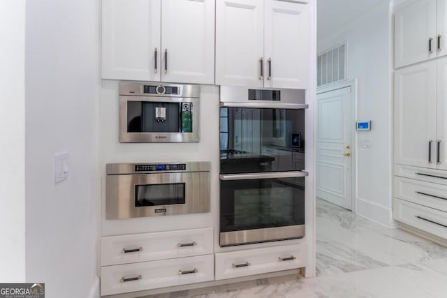 kitchen featuring double oven and white cabinetry