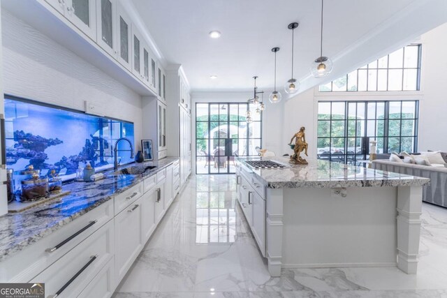 kitchen with pendant lighting, a healthy amount of sunlight, and white cabinetry