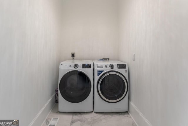 washroom with independent washer and dryer