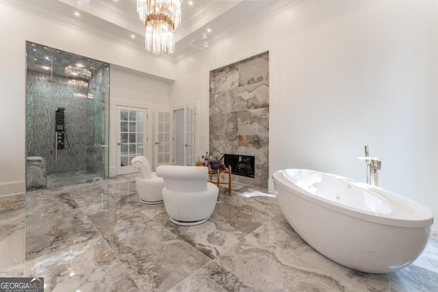 bathroom with ornamental molding, a tiled fireplace, and separate shower and tub