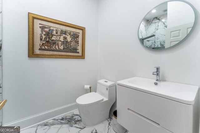 bathroom featuring toilet and vanity