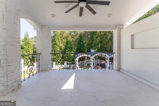 view of patio / terrace featuring ceiling fan and a balcony