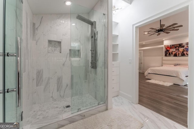 bathroom featuring wood-type flooring, ceiling fan, and a shower with shower door