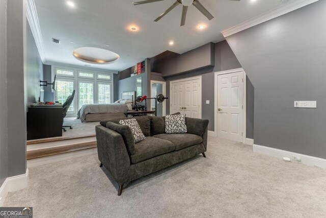 carpeted living room with crown molding and ceiling fan