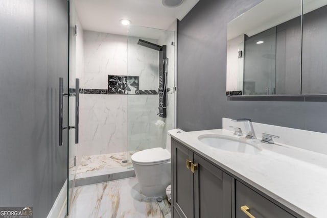 bathroom featuring vanity, toilet, and a shower with door