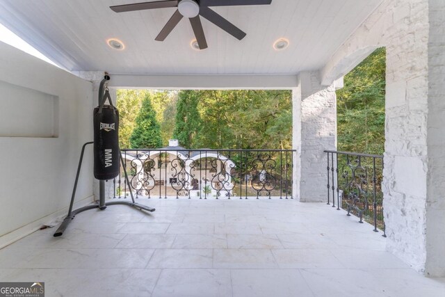 view of patio featuring ceiling fan and a balcony