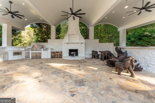 view of patio featuring grilling area, an outdoor kitchen, and ceiling fan