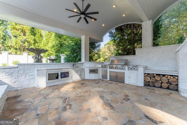 view of patio / terrace with exterior kitchen, ceiling fan, and grilling area