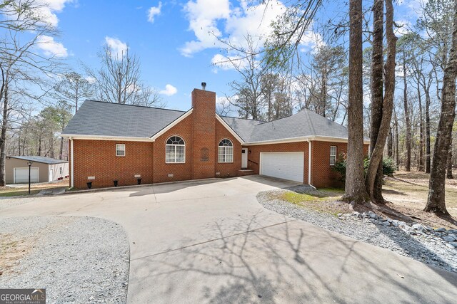 view of property exterior featuring a garage and a lawn