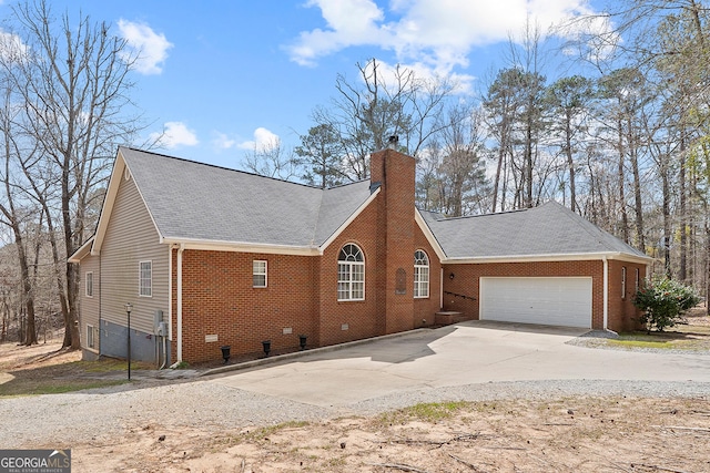 view of home's exterior featuring a garage, a chimney, driveway, and a shingled roof