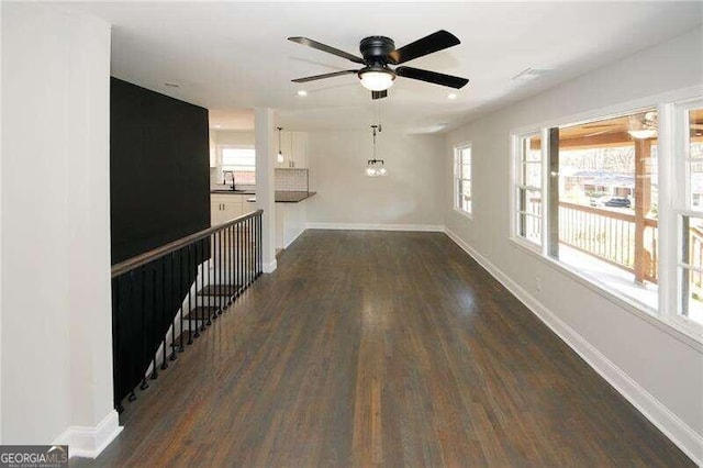 interior space featuring ceiling fan, sink, and dark hardwood / wood-style flooring