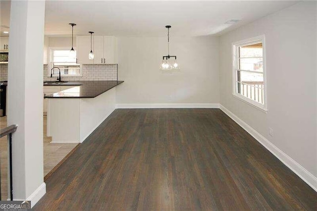 interior space featuring a notable chandelier, dark hardwood / wood-style floors, and sink