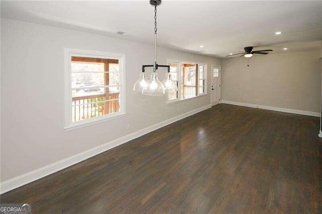 unfurnished dining area with dark hardwood / wood-style flooring and ceiling fan