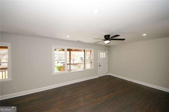 unfurnished room featuring ceiling fan and dark hardwood / wood-style floors