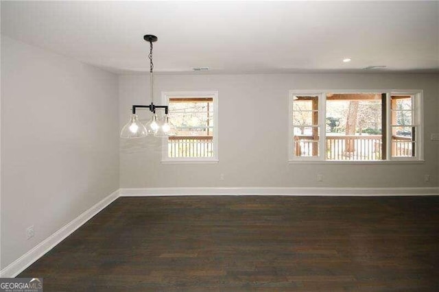 empty room featuring dark hardwood / wood-style floors and a healthy amount of sunlight