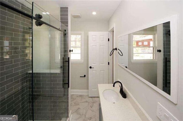 bathroom with an enclosed shower and vanity