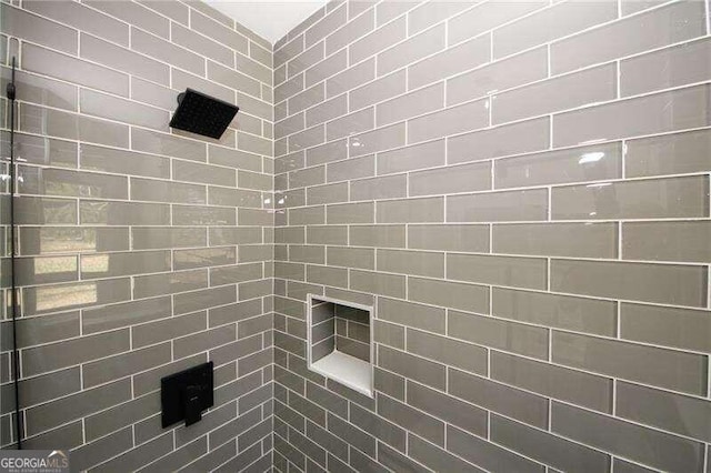 bathroom with tiled shower