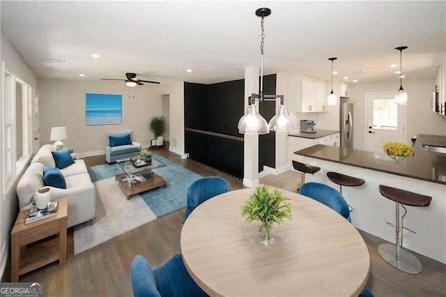 living room featuring wood-type flooring and ceiling fan