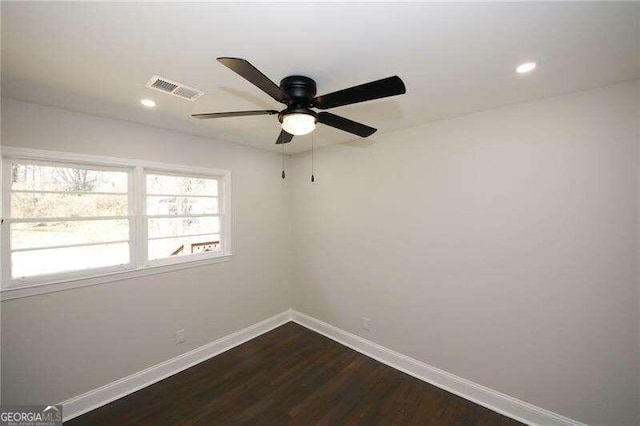 empty room with dark hardwood / wood-style flooring and ceiling fan