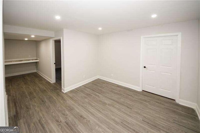 basement featuring dark hardwood / wood-style floors